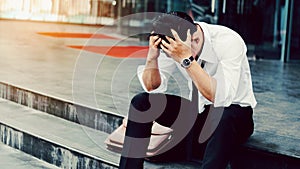 Unemployed Tired or stressed businessman sitting on the walkway photo