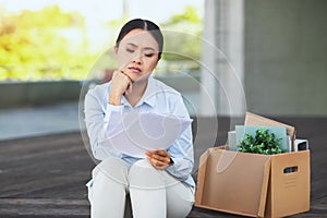 An unemployed woman sitting with her box of office properties