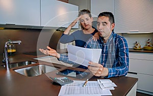 Unemployed young couple with debts reviewing their bank accounts