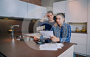 Unemployed young couple with debts reviewing their