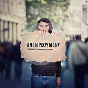 Unemployment as global issue. Unemployed man activist holding a cardboard banner, participating in a street demonstration protest