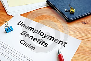 Unemployment benefits claim and stack of papers