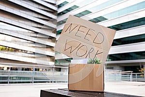 Unemployment Concept. Placard With Need Work Text Put In Box With Belongings