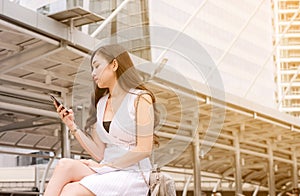 Unemployment problem concept,Asian beautiful woman connection internet find new job on cell phone while sitting outdoor