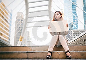 Unemployment. businesswoman with sign looking for a job.