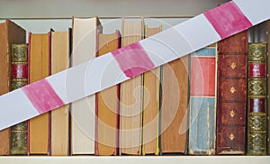 Unequal educational opportunities, books and barrier tape, symbol