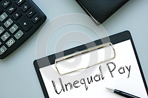 Unequal Pay is shown on the conceptual business photo