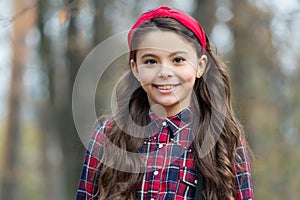 Unequaled in beauty. Beauty look of adorable child. Happy little beauty outdoors. Small girl smile with long brunette photo