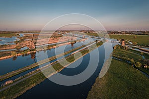 Unesco Werelderfgoed Kinderdijk Molens, Aerial view of Ancient Windmills at dusk in Kinderdijk in Netherlands photo