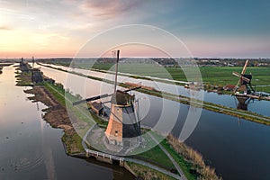 Unesco Werelderfgoed Kinderdijk Molens, Aerial view of Ancient Windmills at dusk in Kinderdijk in Netherlands photo