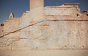 UNESCO World Heritage Site, carved animals and wariors on historical walls of ruined palace of Persepolis