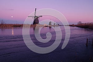 UNESCO World Heritage windmill stands in the evening light in Kinderdijk, near Rotterdam Netherlands