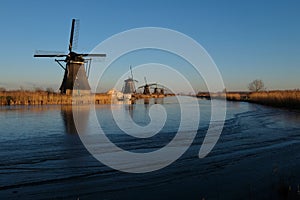 UNESCO World Heritage windmills stand as waters are partially frozen in Kinderdijk, near Rotterdam Netherlands