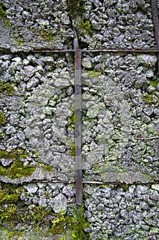 Uneven solidifying old concrete in metal grating-background