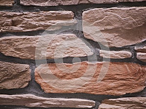 Uneven stone facade close-up. Torn stone texture. Stone wall. Stonewall abstract background