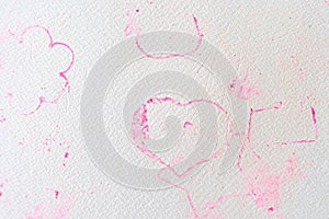 Uneven surface of paper texture with imprints of pink play clay in shape of heart and floral pattern