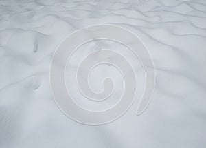 Uneven white snow surface on the ground