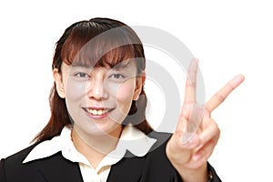 unfashionable Asian businesswoman showing a victory sign