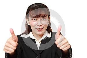 Unfashionable businesswoman with thumbs up gesture