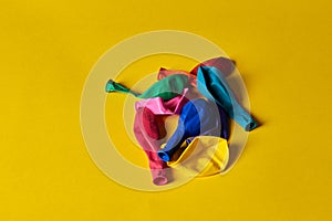 unfilled balloons lie on a yellow background