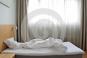 Unfilled bed in motel room