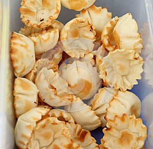 Unfilled pastry shells on a container