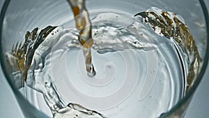 Unfiltered drink jet pouring glass closeup. Craft intoxicant beer filling vessel