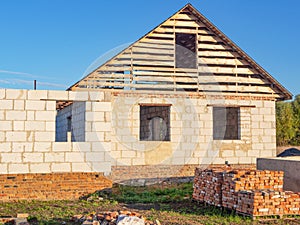 Unfinished attic house roofing construction trusses, wooden beams, eaves, timber. House frame construction