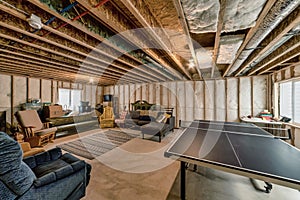 Unfinished basement interior with wooden beam and posts