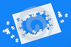 Unfinished blank jigsaw puzzle pieces on blue background. Flat lay