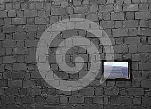 Unfinished brick wall with a window, with a rustic landscape