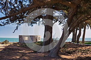 Unfinished clay hut at Gambian beach in sunset