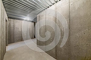 Unfinished empty cold storage room in a basement of a house