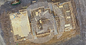 Unfinished frame of apartment condo with wooden roof beams under construction. Development of residential housing in US