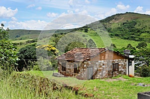 An unfinished house and the hill in the city of Andrelândia in Minas Gerais