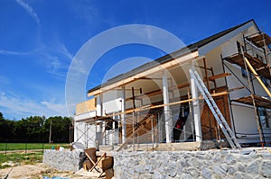 Unfinished house. Home Remodeling and Renovation. Painting house wall with stucco and plastering. Insulation House Wall photo