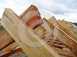 Unfinished house rooftop roofing construction trusses, wooden beams, eaves, timber.  House roof wooden frame construction