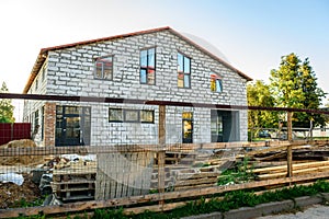 Unfinished house from a white brick. Construction of private houses