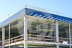 Unfinished metal frame of a new modern industrial building with utilities