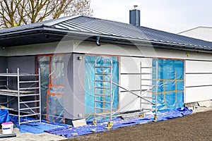 Unfinished modern precast single storey thermally insulated private house with gray metal roof