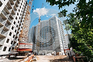 Unfinished multi-storey residential building of bud blocks at a construction site on a sunny day
