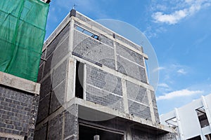 Unfinished private home of ceramsite concrete blocks on a construction site photo