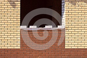 Unfinished red brick house wall . Window house on construction site. Brickwork