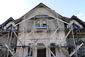 Unfinished residential home in construction progress at building site