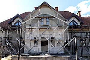 Unfinished residential home in construction progress at building site