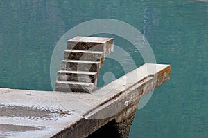 Unfinished staicase over the water