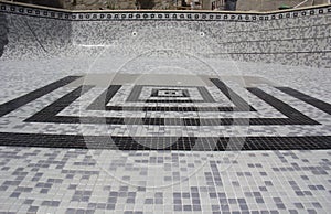 Unfinished Tiled Motif design being applied to refurbished swimming pool.