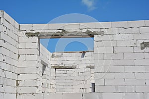 Unfinished white blocks huose construction with door lintel