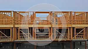Unfinished wood framing complex construction site with wooden framework of urban apartment