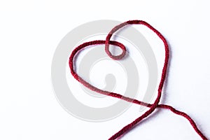 Unfinished wool and knitting needle design. Red thread and tangle. Handmade concept. Craft banner. Love, romantic, valentines day